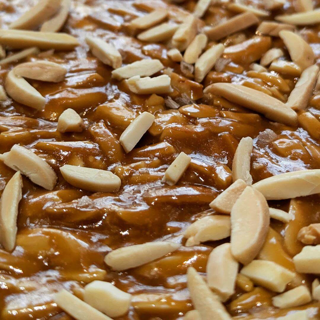 Close up of almond and smoked sea salt brittle in the tray